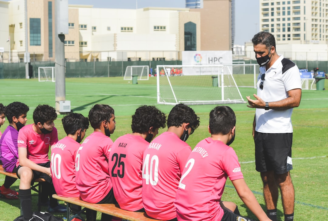 building confidence in young athletes - group of men in red and white soccer jersey