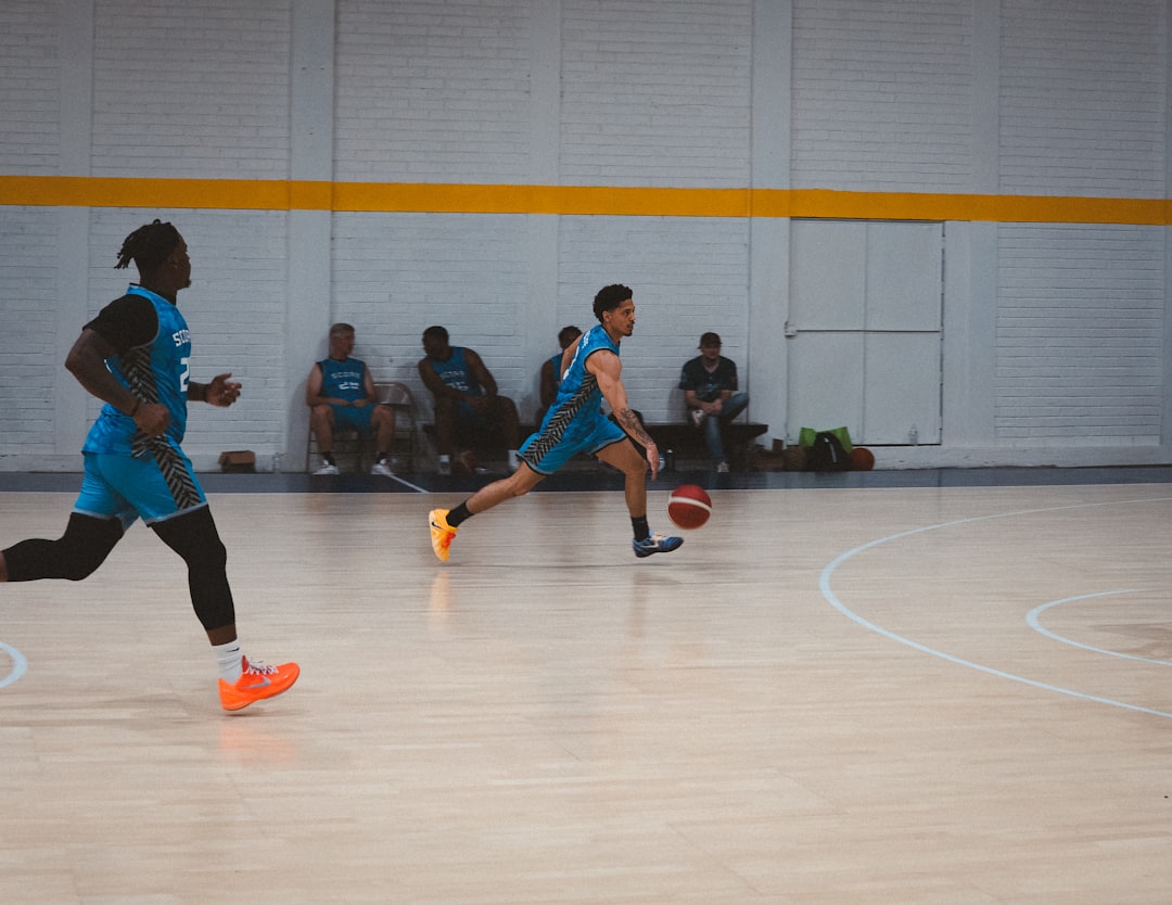 Basketball Shooting Form: 7 Steps to a Perfect Shot Every Time 1 basketball shooting form - Two men playing basketball on an indoor court