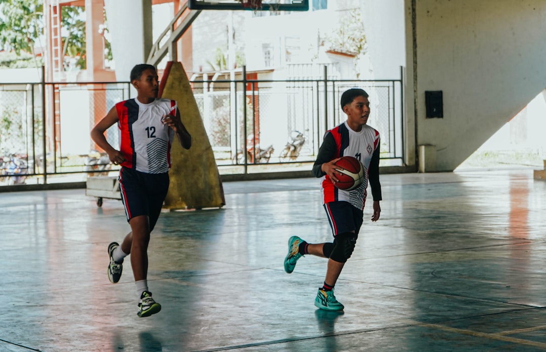 How to Run a Successful Youth Sports Tryout: 7 Essential Tips for Coaches 1 youth sports tryout - A group of young men playing a game of basketball
