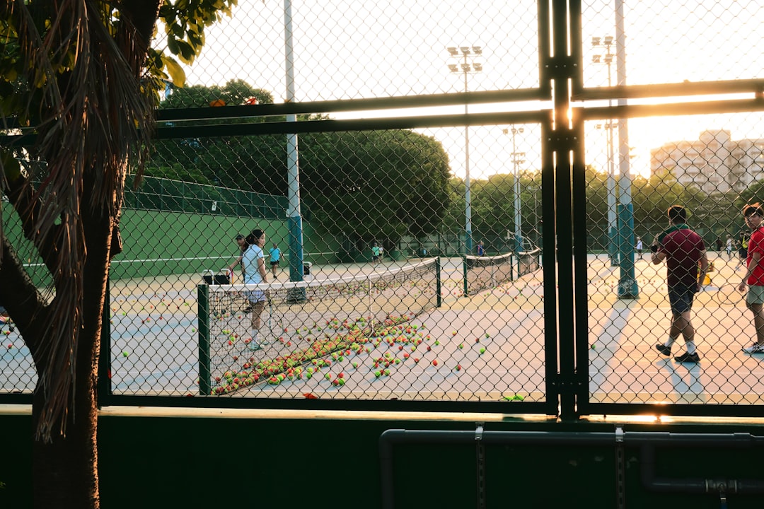 tennis drills for beginners - A group of people playing a game of tennis