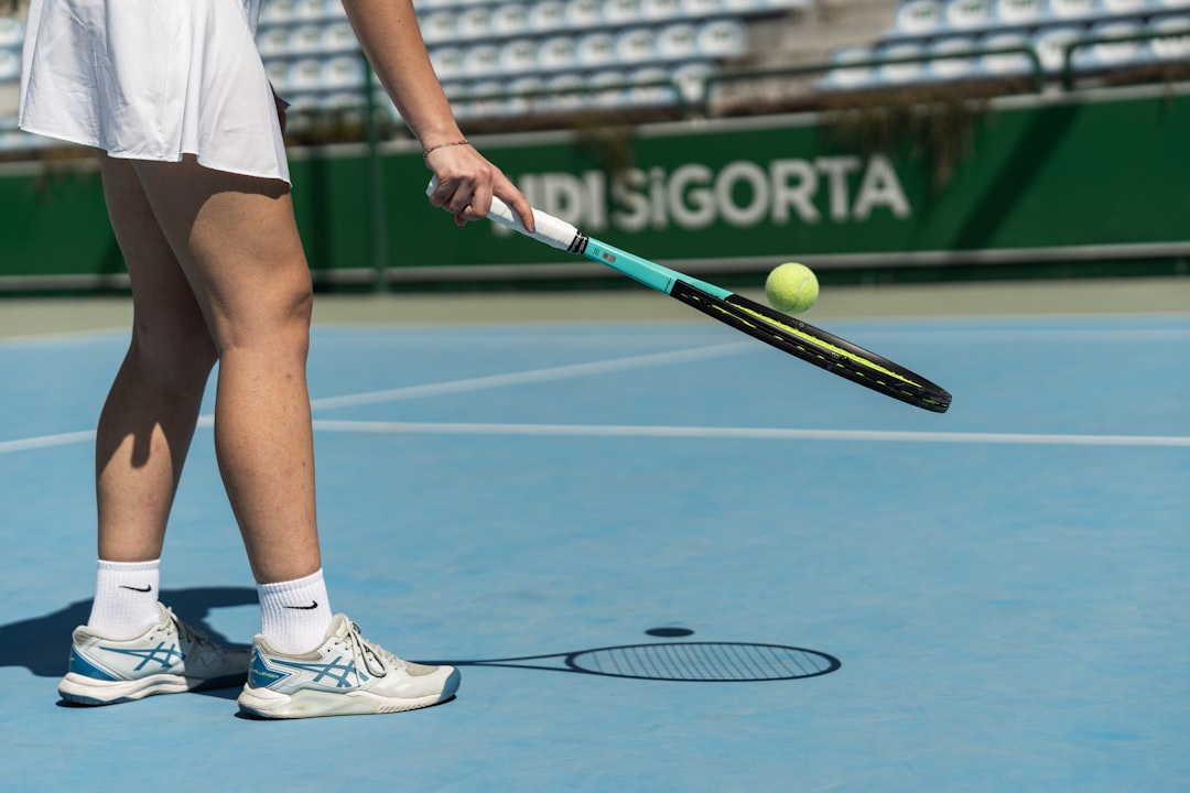 tennis drills for beginners - a tennis player prepares to hit a tennis ball