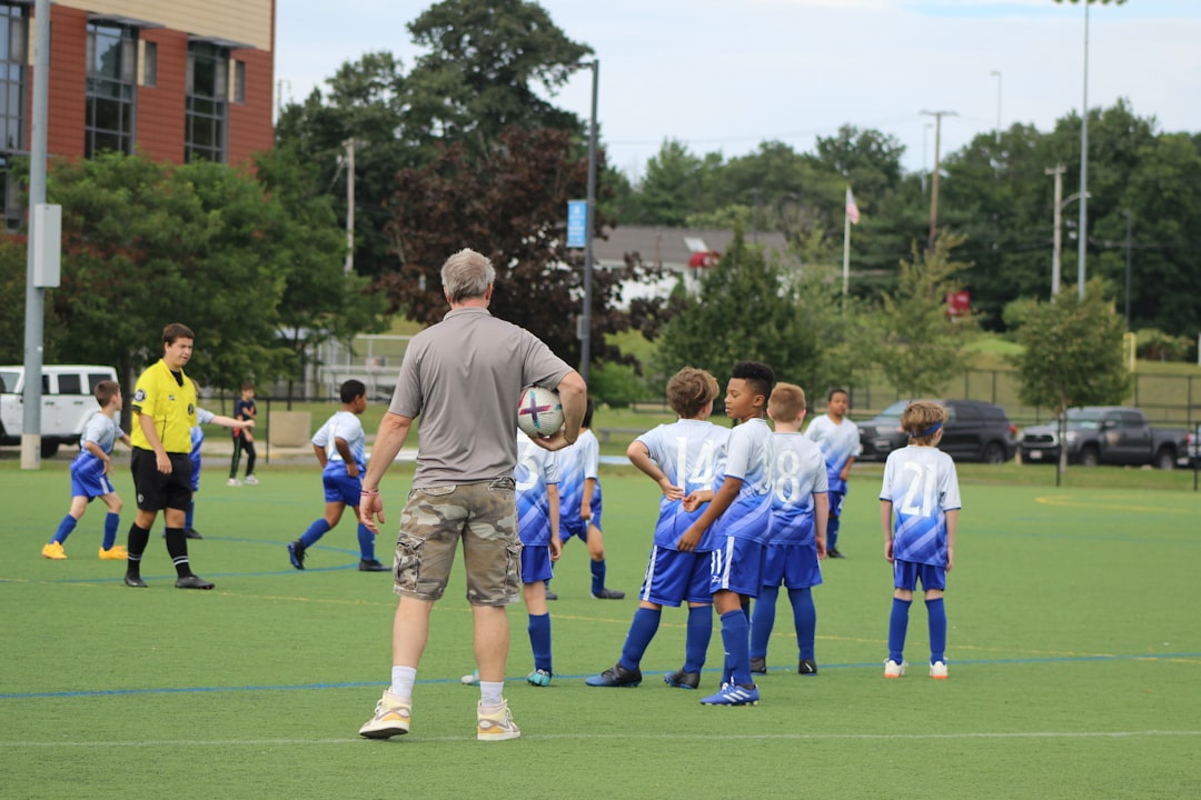 youth football conditioning drills - a group of young men standing on top of a soccer field