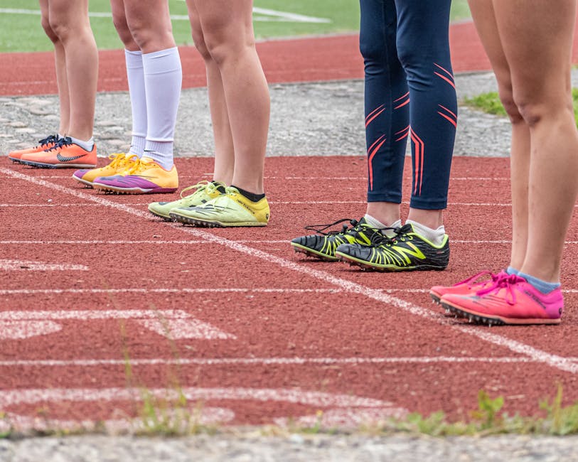 youth sports news April 2026 - Group of runners preparing to start a race with vibrant footwear on a track.