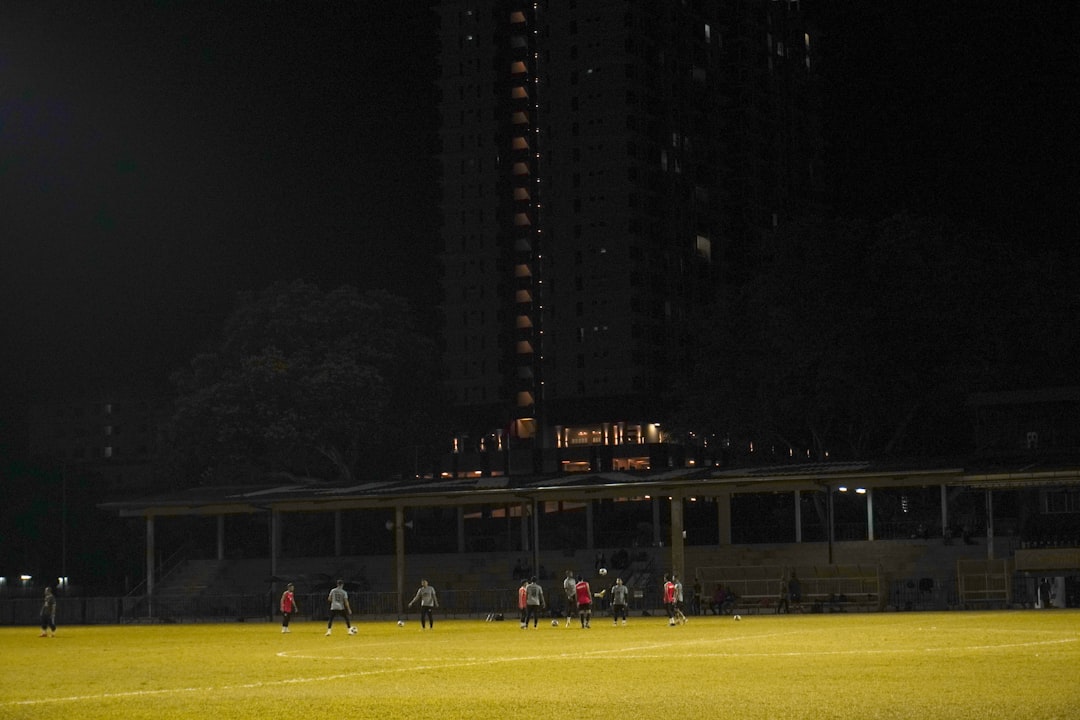 youth sports news May 2026 - a group of people standing on top of a soccer field